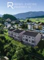 Detached houses with modern design, set in a rural landscape, large windows, solar panels