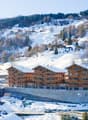 wooden exterior, multi-level residential building, large windows, snow covered surroundings, under construction area