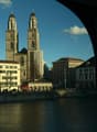 View of a city with a large church, buildings, and a river