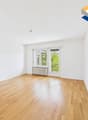 empty room, wooden floor, white walls, large window, balcony