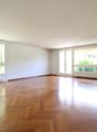 spacious room, hardwood floors, large windows, sunny, clean