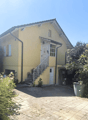Single story house, yellow painted exterior, garage attached, brick flooring in driveway