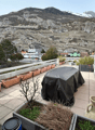 Outdoor space, covered terrace, green landscape, trees, mountains, covered table, wooden deck