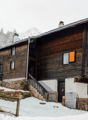 2 story wooden house, slanted roof, multiple windows, wooden fences