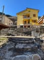 yellow facade, stone wall, steps, balcony