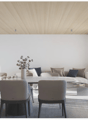 white walls, wooden ceiling, dining table with chairs, couch, outdoor balcony with chairs, plants, open sliding doors, and view of mountain