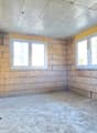 empty room, brick walls, concrete floor, two windows, unfinished