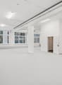 Empty room with white walls, white floor, large windows, white ceiling, white door, white pillars