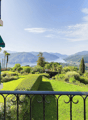 balcony with railings, view of a lake and mountains