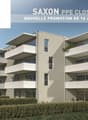 A modern apartment building with a unique design, situated in a mountainous area, featuring balconies on each floor and surrounded by greenery.