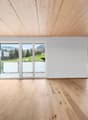 large windows, sliding glass doors, wooden floor, balcony, view of the outside