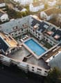 Residential building, multiple units, rooftop solar panels, central swimming pool, courtyard area