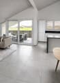modern apartment with large windows, glass sliding door, balcony, dining table, kitchen island, sofa