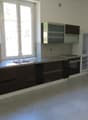 Kitchen with a sink, faucet, oven, and refrigerator under the window.