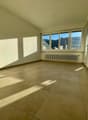 empty room with tiled floor, white walls, window, radiator