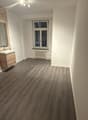 empty room, wooden floor, bathroom sink, mirror, window, radiator