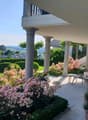 covered terrace with columns, flowers, swimming pool, garden, view of the mountains