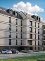 multi-storey building, numerous balconies, multiple parking spaces, surrounded by greenery