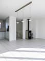 empty room, white tiles, white walls, kitchen area, fireplace, hanging lamps
