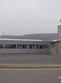 large industrial building, tower, open space, large windows, cloudy sky