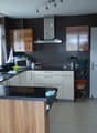 modern kitchen with wooden cabinets, black granite countertops, white appliances, tiled floor, window