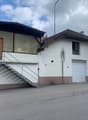 2 story building, white and brown walls, 2 garages, stairs