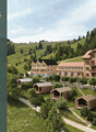 Aerial view of a group of wooden buildings on a hillside surrounded by trees and grass