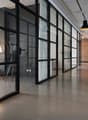modern office space, glass walls, concrete floor, white walls, modern furniture, lamps