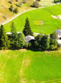 green grass, hills, houses, driveway, trees, car