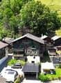 Mountain village, traditional wooden chalet, large garden, several buildings, panoramic views, solar panels, car parking