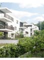 white modern apartments, balconies, green surroundings