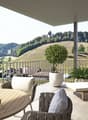balcony with table and chairs, lounge, railing, plants, rural view
