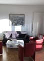 Large room with modern furniture, two sofas, coffee table, and a framed picture on the wall.