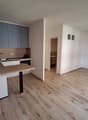 modern kitchen, equipped with stainless steel appliances, wooden countertops, white cabinets, hardwood floors, open to the living area