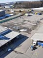 Large industrial complex with warehouses, storage facilities, and parking areas. The area appears to be used for commercial and logistical purposes.
