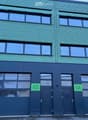 Blue facade, three glass windows per floor, two garage doors, labeled 04 and 05
