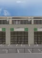 Industrial building with 4 parking spots in front, 4 doors labeled 10 to 13.