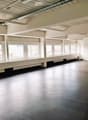 empty room, large windows, gray floors, white walls, long benches