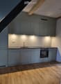 modern kitchen, wood floor, gray cabinets, modern sink, gas stove, under-cabinet lighting