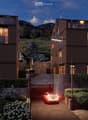 2 story house, brown exterior, multiple balconies, garage, garden, mountain view
