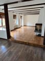 empty room, wooden floor, tiled floor, fireplace, windows, wooden beams