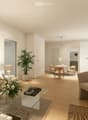 living room with couch, coffee table, armchair, dining area with table and chairs, kitchen with appliances