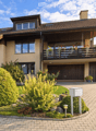 2 story house, brown roof, beige walls, balcony, driveway, garden, garage