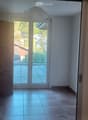 empty room, wooden cabinet, sliding glass door, balcony, tiled floor