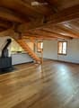 wooden ceiling, wooden floor, fireplace, open kitchen, stairs