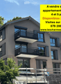 Modern multi-story residential building with balconies, large windows, and a contemporary design.