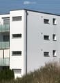 white exterior, glass balcony railings, multiple windows, 5 stories