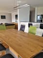 large table, modern chairs, modern kitchen island, hanging lamp, modern artwork