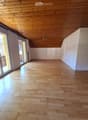 empty room, wooden floor, wooden ceiling, sliding glass doors, balcony