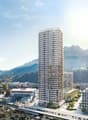 Building. A modern high-rise building stands prominently in the foreground, surrounded by smaller structures and a scenic mountainous backdrop.